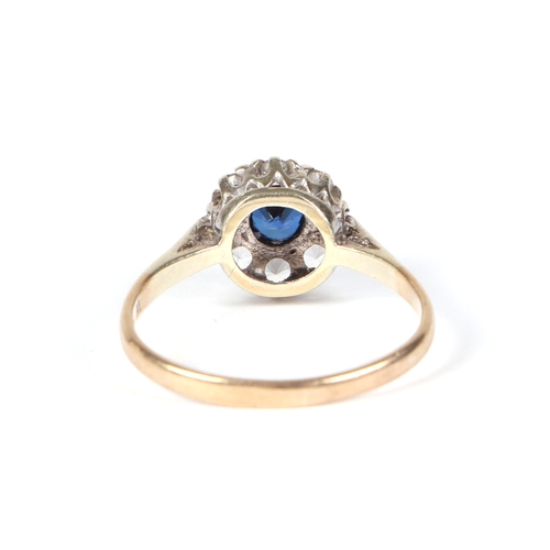 450 - A 9ct gold cluster ring with central blue stone, approx UK size R, 2.6g.