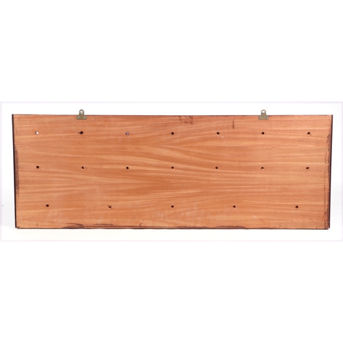 355A - A decorative wall plaque constructed from apothecary drawer fronts, 122.5cms wide.