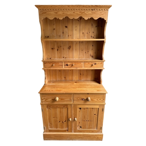 745 - A modern pine dresser, the plate rack with three drawers, on a dresser base with two frieze drawers ... 