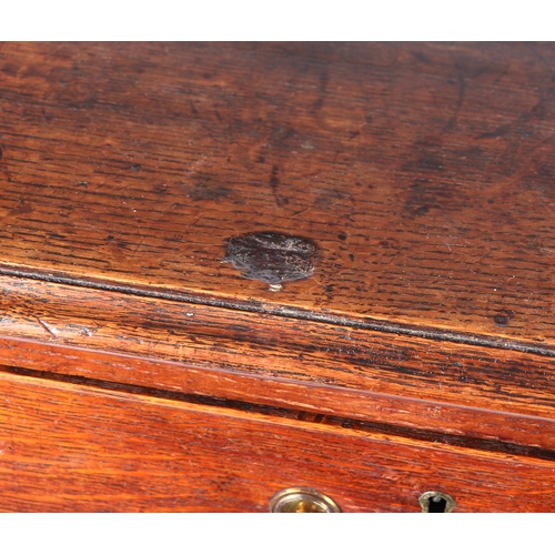 743 - A George III oak chest of two short and three graduated long drawers, on ogee bracket feet, 101cms w... 