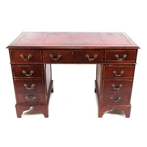 737 - A George III style mahogany twin pedestal desk with an arrangement of nine drawers, 120cms wide.