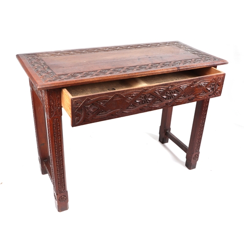 724 - A late 19th century oak side table, the rectangular top with profusely carved decoration, above a si... 