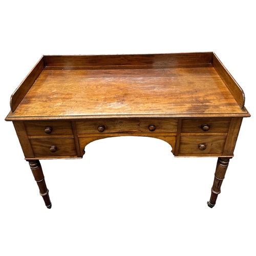 637A - A Victorian mahogany wash stand with an arrangement of five drawers, on ring turned legs terminating... 