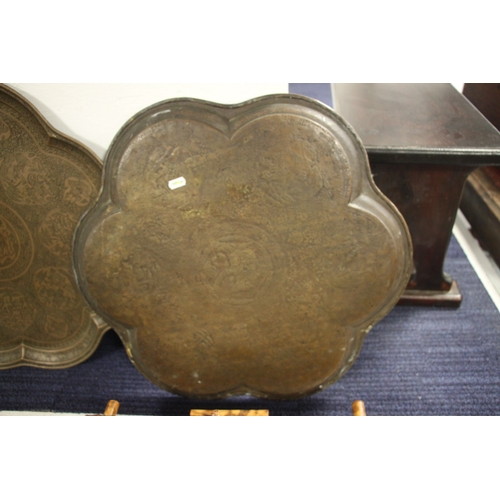 501 - A Persian brass tray of shaped form decorated with figures within panels and foliate scrolls, 57cms ... 