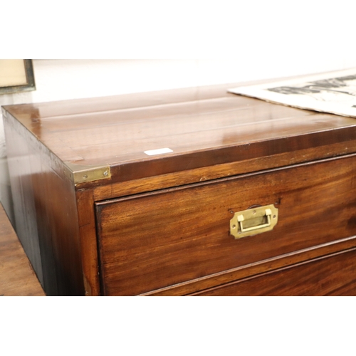 662 - A mahogany Campaign chest with four graduated long drawers with recessed brass handles, on turned le... 