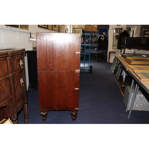 662 - A mahogany Campaign chest with four graduated long drawers with recessed brass handles, on turned le... 