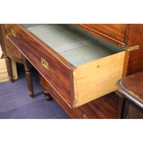 662 - A mahogany Campaign chest with four graduated long drawers with recessed brass handles, on turned le... 