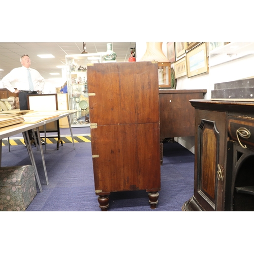 662 - A mahogany Campaign chest with four graduated long drawers with recessed brass handles, on turned le... 