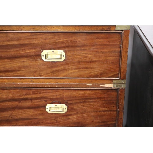 662 - A mahogany Campaign chest with four graduated long drawers with recessed brass handles, on turned le... 