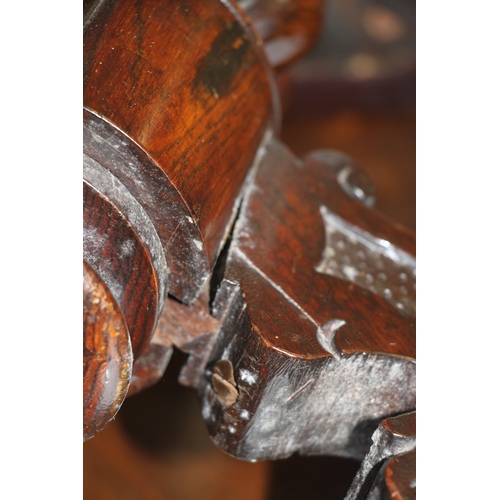 705 - A Victorian carved walnut adjustable piano stool on a tripod base with carved acanthus leaf decorati... 