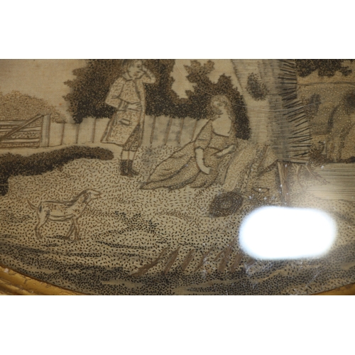 34 - An 18th century English oval silkwork embroidered panel depicting a landscape with a couple beneath ... 