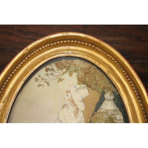 33 - A 19th century silk needlework oval panel depicting a young lady with white dress and bonnet holding... 