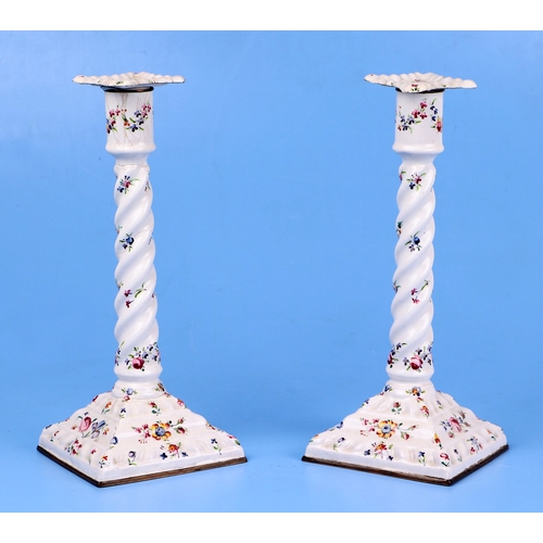 347 - A pair of late 18th century South Staffordshire enamel candlesticks decorated with sprays of flowers... 