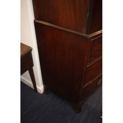 727 - A George III mahogany bowfront linen press with dentil cornice above a pair of panelled doors enclos... 