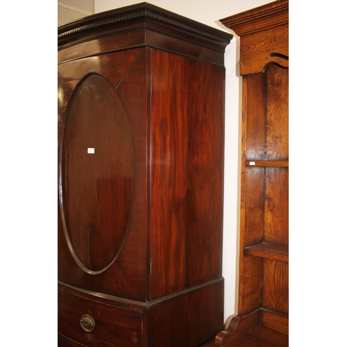 727 - A George III mahogany bowfront linen press with dentil cornice above a pair of panelled doors enclos... 