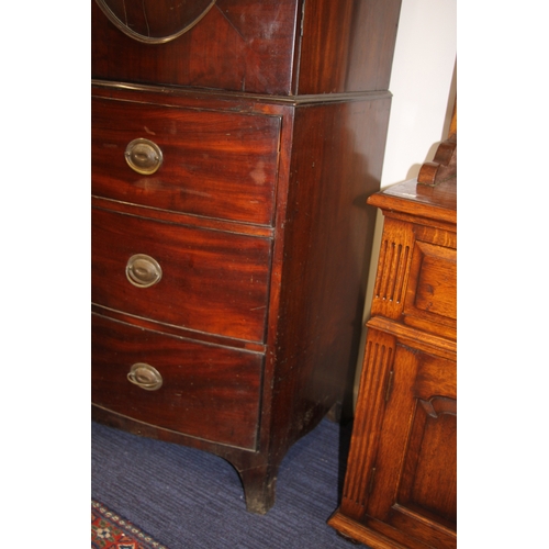 727 - A George III mahogany bowfront linen press with dentil cornice above a pair of panelled doors enclos... 