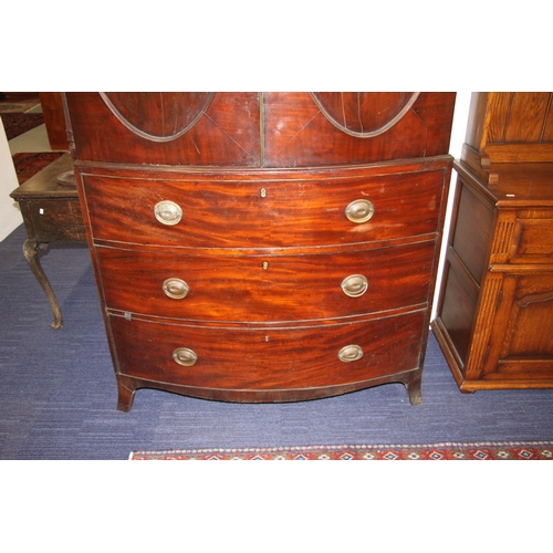 727 - A George III mahogany bowfront linen press with dentil cornice above a pair of panelled doors enclos... 