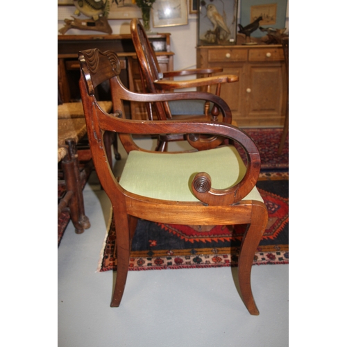 697 - A Regency mahogany desk chair with upholstered drop-in seat, on sabre front supports.