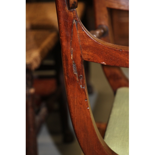 697 - A Regency mahogany desk chair with upholstered drop-in seat, on sabre front supports.