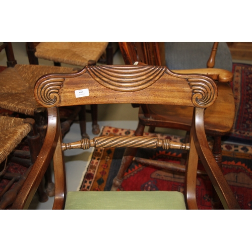 697 - A Regency mahogany desk chair with upholstered drop-in seat, on sabre front supports.