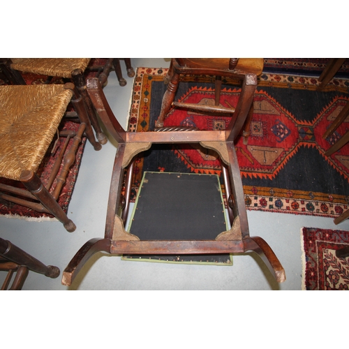 697 - A Regency mahogany desk chair with upholstered drop-in seat, on sabre front supports.