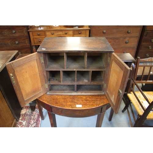 573 - A late 19th / early 20th century oak table top cupboard, the pair of doors enclosing pigeon holes, 4... 