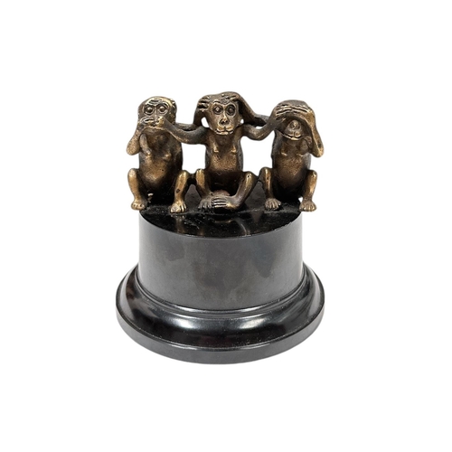 31 - A Three Wise Monkeys brass accessory car mascot mounted on a plinth, approx 8cms wide.