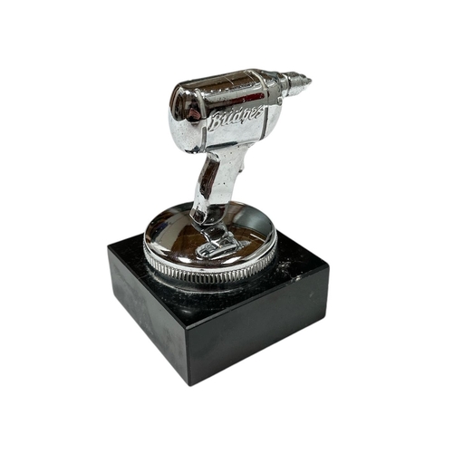 36 - A British Electric Co chrome plated accessory car mascot in the form of a drill, mounted on a plinth... 