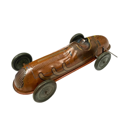 58 - A Mettoy tin plate clockwork single seat racing car with lithograph printed decoration, 30cms long.