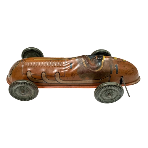 58 - A Mettoy tin plate clockwork single seat racing car with lithograph printed decoration, 30cms long.