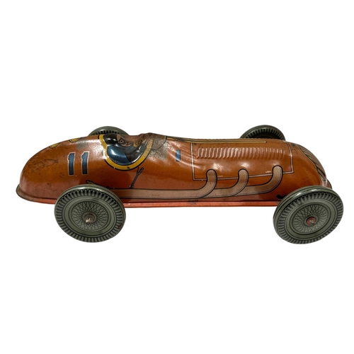 58 - A Mettoy tin plate clockwork single seat racing car with lithograph printed decoration, 30cms long.