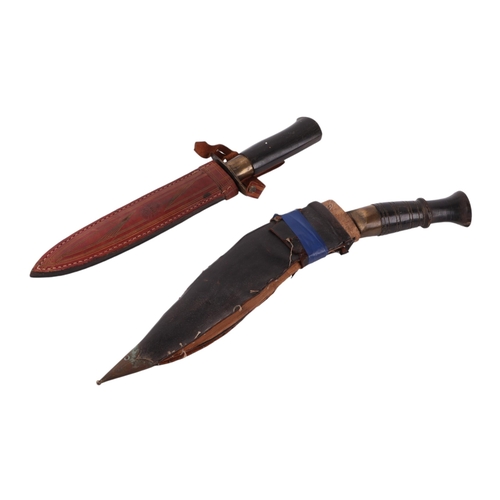 107 - A Kukri in leather scabbard; together with a Middle Eastern double edged dagger with ebonised handle... 