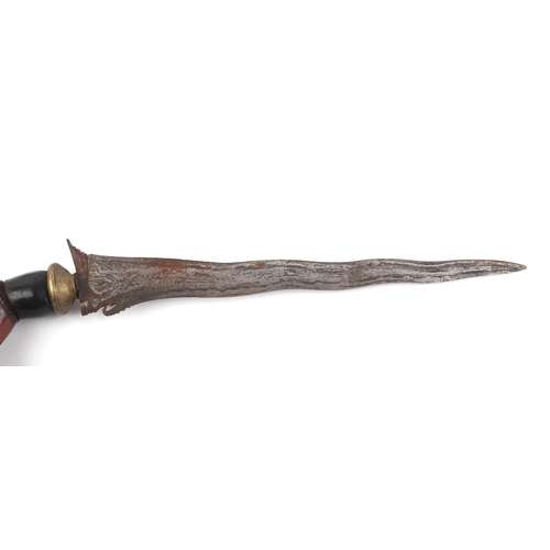 111 - A 19th century Indonesian Kris with wavy edged blade with hardwood handle and scabbard, blade length... 