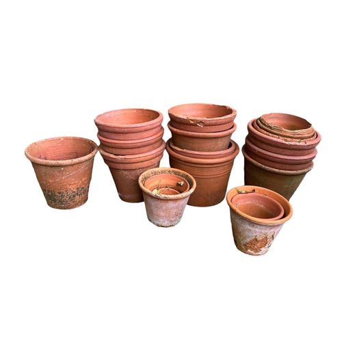 12 - A quantity of terracotta plant pots;  galvanised watering cans; a butler's sink and a wrought iron s... 