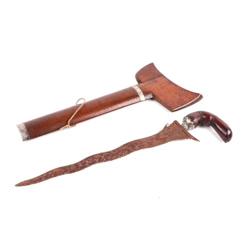 122 - An Indonesian Kris with wavy steel blade in a hardwood scabbard, 42cms long; together with two simil... 