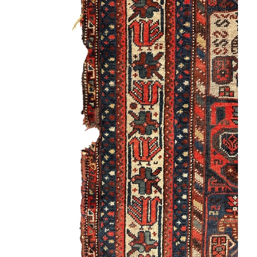 125 - A Persian Bakhtiar rug decorated with a multitude of medallions, on a red ground, 165 by 200cms.