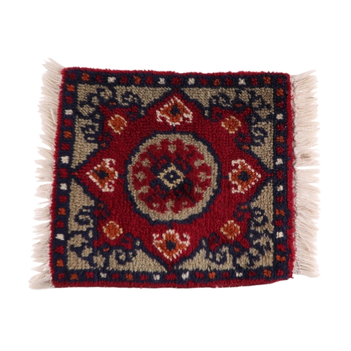 127 - A group of three hand knotted sample rugs, each 37 by 39cms (3).