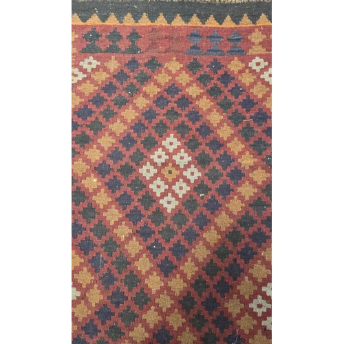 130 - A Kilim rug with geometric design, on a red ground, 95 by 178cms.