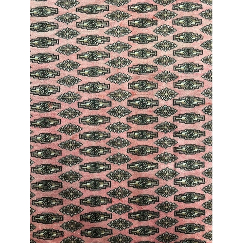 139 - A Persian Turkoman rug with repeating guls within borders, on a red ground, 200 by 260cms.