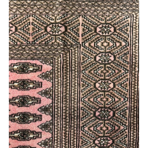 139 - A Persian Turkoman rug with repeating guls within borders, on a red ground, 200 by 260cms.