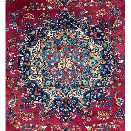 142 - A Persian hand knotted woollen rug with central gul within multi borders, 370 by 290cms.