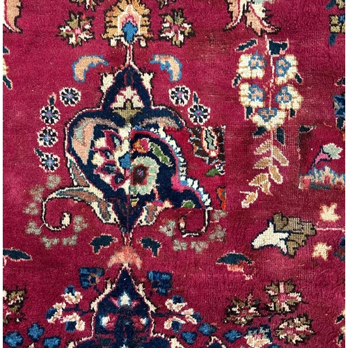 142 - A Persian hand knotted woollen rug with central gul within multi borders, 370 by 290cms.