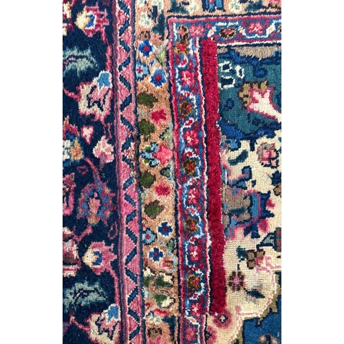 142 - A Persian hand knotted woollen rug with central gul within multi borders, 370 by 290cms.