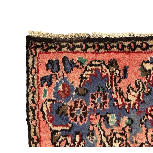 144 - A Persian Hamadan woollen hand knotted rug with central floral gul, on a beige ground, 155 by 225cms