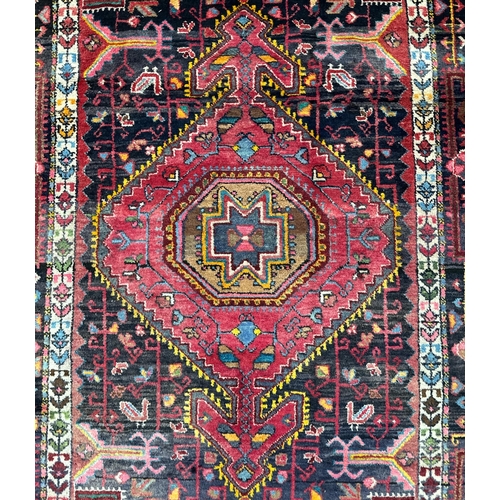 151 - A Persian Nahavand hand knotted rug, the central medallion framed by stylised floral designs and fou... 