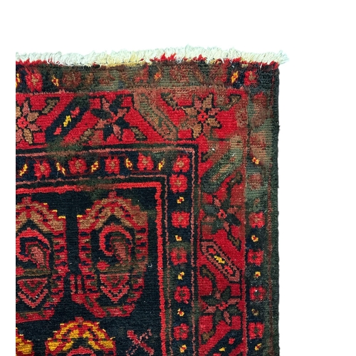 155 - A Persian Hamadan hand knotted woollen rug with repeating boteh design within floral borders, on a n... 