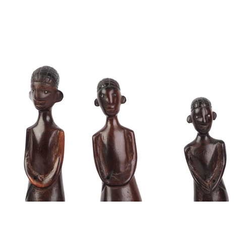 26 - An African hardwood carved figural group depicting a canoe and five figures, 70cms long.