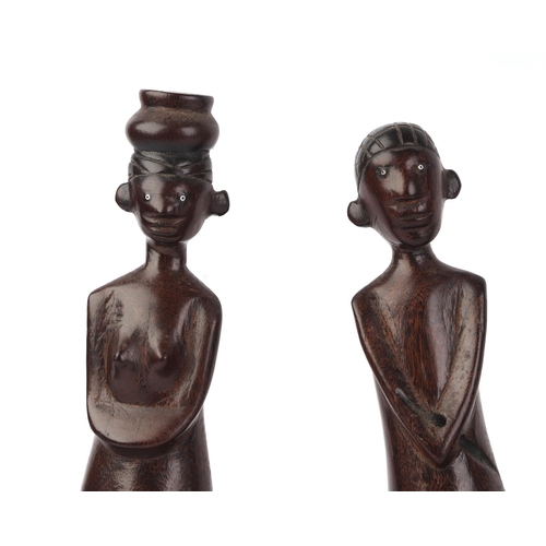 26 - An African hardwood carved figural group depicting a canoe and five figures, 70cms long.