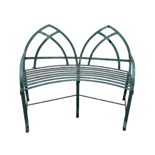 8 - A well weathered iron strapwork Gothic two-seater garden bench, 119cms wide.