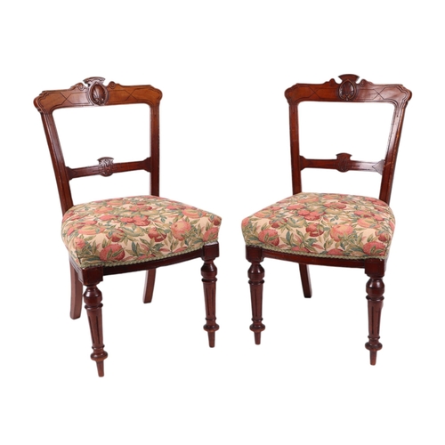 824 - A set of six late Victorian / Edwardian walnut dining chairs with carved back rails, over-stuffed se... 